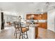 Bright kitchen featuring wooden cabinets, tile flooring, and an island with seating at 1147 E Harvest Rd, San Tan Valley, AZ 85140