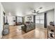 Bright living room with hardwood floors, ceiling fan, and comfortable gray sofas at 1147 E Harvest Rd, San Tan Valley, AZ 85140
