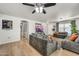 Cozy living room with neutral walls, gray couches and wood-look flooring at 1147 E Harvest Rd, San Tan Valley, AZ 85140