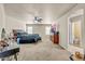 Large bedroom with carpet, ceiling fan, vanity, and an ensuite bathroom at 1147 E Harvest Rd, San Tan Valley, AZ 85140