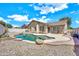 Scenic backyard view featuring a free-form pool, covered patio, and low-maintenance landscaping at 1147 E Harvest Rd, San Tan Valley, AZ 85140