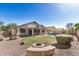 Large backyard featuring a pool, grass, and desert landscaping at 13020 W Highland Ave, Litchfield Park, AZ 85340