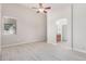 Bright bedroom boasts wood-look floors and an archway to a bathroom at 13020 W Highland Ave, Litchfield Park, AZ 85340