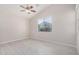 Bright bedroom with wood-look floors, neutral walls, and a window overlooking the neighborhood at 13020 W Highland Ave, Litchfield Park, AZ 85340