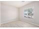 Bright bedroom with wood-look floors and a window overlooking the neighborhood at 13020 W Highland Ave, Litchfield Park, AZ 85340