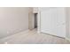 A neutral bedroom showcasing a closet and modern wood-look flooring at 13020 W Highland Ave, Litchfield Park, AZ 85340