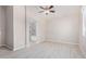 Open bedroom boasts wood-look floors and an archway to a tiled bathroom at 13020 W Highland Ave, Litchfield Park, AZ 85340