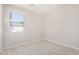 A well-lit bedroom with a window and modern wood-look flooring at 13020 W Highland Ave, Litchfield Park, AZ 85340