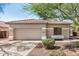 Home exterior featuring neutral paint, tile roof, and two-car garage at 13020 W Highland Ave, Litchfield Park, AZ 85340