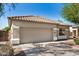 Home exterior showcasing garage door, neutral paint, tile roof, and desert landscaping at 13020 W Highland Ave, Litchfield Park, AZ 85340