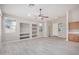 Bright living room with wood-look floors, built-in shelves, and abundant natural light at 13020 W Highland Ave, Litchfield Park, AZ 85340
