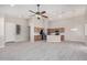 Spacious open-concept room with wood-look floors and kitchen area at 13020 W Highland Ave, Litchfield Park, AZ 85340