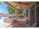 Covered back patio features tiled floor, ceiling fan, and built-in grill at 14039 S 33Rd Way, Phoenix, AZ 85044