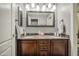 Bathroom features a double sink vanity with a granite countertop and ornate dark wood cabinets at 14039 S 33Rd Way, Phoenix, AZ 85044