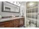 Bathroom featuring a double sink vanity with granite counters, and a shower/toilet area with a striped curtain at 14039 S 33Rd Way, Phoenix, AZ 85044