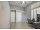 Well-lit bedroom featuring gray walls, a ceiling fan, and a work space with a desk and chair at 14039 S 33Rd Way, Phoenix, AZ 85044