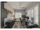 Well-lit bedroom featuring a ceiling fan, plantation shutters, work space, and a cozy rug at 14039 S 33Rd Way, Phoenix, AZ 85044