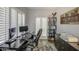 Bedroom featuring plantation shutters, a ceiling fan, workspace, and decorative shelving at 14039 S 33Rd Way, Phoenix, AZ 85044