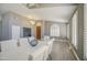 Bright dining area with modern light fixture, white dining set, plantation shutters, and hardwood floors at 14039 S 33Rd Way, Phoenix, AZ 85044