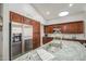 Well-equipped kitchen with stainless steel appliances, granite counters, dark wood cabinetry, and ample storage at 14039 S 33Rd Way, Phoenix, AZ 85044