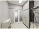 The laundry room features storage cabinets, sliding glass doors and neutral tile floor at 14039 S 33Rd Way, Phoenix, AZ 85044