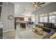 Open concept kitchen and living room with modern gray walls, wooden floors, and stainless steel appliances at 14039 S 33Rd Way, Phoenix, AZ 85044