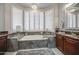 This bathroom boasts a soaking tub, and cherry cabinets at 14039 S 33Rd Way, Phoenix, AZ 85044