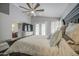 Comfortable main bedroom featuring ensuite bathroom access, ceiling fan and private patio access at 14039 S 33Rd Way, Phoenix, AZ 85044
