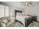 Comfortable main bedroom with a ceiling fan, bedside lamps, and a plush armchair at 14039 S 33Rd Way, Phoenix, AZ 85044