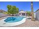 Backyard pool with surrounding rock landscaping and mature shade trees under a clear blue sky at 14039 S 33Rd Way, Phoenix, AZ 85044