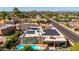Wide aerial view showcases the backyard pool, solar panels, and surrounding neighborhood at 15630 N 20Th St, Phoenix, AZ 85022