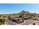 This is an aerial image of a home with beautiful desert landscaping, a two car garage, and mountain views at 15630 N 20Th St, Phoenix, AZ 85022