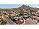 An aerial view of a community highlighting the neighborhood, mountain views and a meticulously landscaped yard at 15630 N 20Th St, Phoenix, AZ 85022