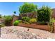 Beautiful backyard features a rock garden, various plants, flowers, and a charming desert landscape at 15630 N 20Th St, Phoenix, AZ 85022