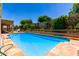 Expansive backyard with a refreshing swimming pool, lounge chairs, and lush greenery offers an ideal setting for leisure at 15630 N 20Th St, Phoenix, AZ 85022