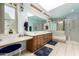 Bathroom with dual sinks, large mirror, and skylight for natural light at 15630 N 20Th St, Phoenix, AZ 85022