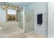 This bathroom showcases a tiled tub, shower, and a large window bringing in natural light at 15630 N 20Th St, Phoenix, AZ 85022