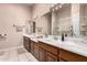 Bathroom with a double sink vanity, large mirror, and tiled flooring at 15630 N 20Th St, Phoenix, AZ 85022