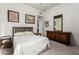 Well-lit bedroom with neutral decor, wooden furniture, and carpeted flooring at 15630 N 20Th St, Phoenix, AZ 85022