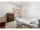 Cozy bedroom with neutral colors, a wooden dresser, and natural light at 15630 N 20Th St, Phoenix, AZ 85022