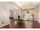Elegant dining room featuring hardwood floors, a glass table, and soft lighting at 15630 N 20Th St, Phoenix, AZ 85022