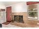 Charming fireplace area with a unique marble surround, decorative screen and view of the outside at 15630 N 20Th St, Phoenix, AZ 85022