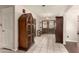 Inviting foyer with tile flooring, beautiful wood doors, and unique decorative cabinets at 15630 N 20Th St, Phoenix, AZ 85022