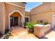 Inviting front entrance with a decorative door, desert landscaping, and tiled walkway at 15630 N 20Th St, Phoenix, AZ 85022
