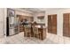 Well-lit kitchen showcases stainless steel appliances and an island with seating at 15630 N 20Th St, Phoenix, AZ 85022