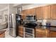 Kitchen featuring stainless steel appliances, including a double oven, and wood cabinets at 15630 N 20Th St, Phoenix, AZ 85022