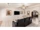 Comfortable seating area with ceiling fan, TV, neutral color scheme, and arched doorway at 15630 N 20Th St, Phoenix, AZ 85022