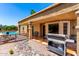 Outdoor grill on the patio with a view of the pool, providing the perfect setting for entertaining and relaxation at 15630 N 20Th St, Phoenix, AZ 85022