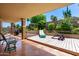 Inviting covered patio with comfortable seating, lush landscaping, and well-maintained decking is ideal for relaxing at 15630 N 20Th St, Phoenix, AZ 85022