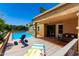 Relaxing backyard featuring a sparkling swimming pool, lounge chairs, and lush landscaping for ultimate relaxation at 15630 N 20Th St, Phoenix, AZ 85022
